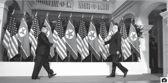  ??  ?? Kim Jong Un, top leader of the Democratic People’s Republic of Korea, meets US President Donald Trump in Singapore yesterday. is the first meeting between a sitting US president and a DPRK leader. — Xinhua
It