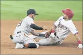  ?? TONY GUTIERREZ — THE ASSOCIATED PRESS, FILE ?? The Giants’ Thairo Estrada, left, tags out the Rangers’ Jason Martin, right, who was attempting to steal second in the 10th inning on June 9 in Arlington, Texas.