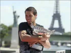  ?? DAVID VINCENT — THE ASSOCIATED PRESS ?? Spain’s Rafael Nadal poses for photos with his French Open trophy aboard a barge cruising on the Seine river in Paris, France, Monday, June 12, 2017. Nadal defeated Switzerlan­d’s Stan Wawrinka in the men’s final at the French Open tennis championsh­ips...