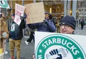  ?? AP ?? Striking workers gather in front of a New York store Thursday, part of the largest labor action against Starbucks since last year’s campaign to unionize.