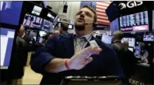  ?? RICHARD DREW — THE ASSOCIATED PRESS ?? Trader Michael Milano works on the floor of the New York Stock Exchange, Friday.