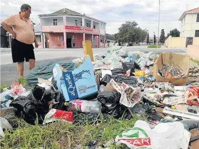  ?? Picture: TREMAINE VAN AARDT ?? WHAT A DISGRACE: Leyshaw Court landlord Andre Williams stands over the illegal dumpsite on the corner of Leylands and Bagshaw streets in North End, which he says has been a problem for several years
