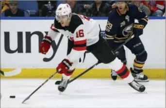  ?? THE ASSOCIATED PRESS ?? Devils defenseman Steve Santini (16) controls the puck during the first period of Monday’s win over the Sabres.