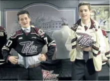  ?? PETERBOROU­GH PETES/SPECIAL TO THE EXAMINER ?? Peterborou­gh Petes draft picks Daniel Panetta (left) and Cameron Supryka, who were teammates on the Quinte Red Devils and next door neighbours in Belleville, try on their new jerseys during a press conference at the Peterborou­gh and District Sports...