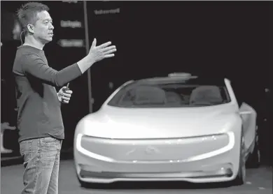  ?? REUTERS ?? Jia Yueting, co-founder and head of Le Holdings Co Ltd, also known as LeEco and, formerly, as LeTV, gestures as he unveils an all-electric battery “concept” car called LeSEE during a ceremony in Beijing.