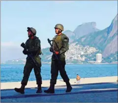  ?? CARL DE SOUZA/AFP ?? Brazilian soldiers patrol Ipanema beach in Rio de Janeiro on April 14.