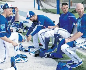  ?? FRANK GUNN / THE CANADIAN PRESS ?? Toronto Blue Jays starting pitchers Aaron Sanchez, Jamie Garcia, Marco Estrada and J.A. Happ, left to right, pack up after working out at spring training in Dunedin on Wednesday.