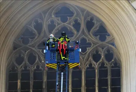  ?? Laetitia Notarianni/Associated Press ?? Firefighte­rs work to extinguish the blaze Saturday at the Gothic St. Peter and St. Paul Cathedral in Nantes, western France.