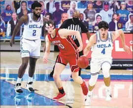  ?? Marcio Jose Sanchez Associated Press ?? UCLA’S Jaime Jaquez, right, dribbles past Utah’s Mikael Jantunen during the second half. The Bruins won in their f irst game in nearly two weeks.