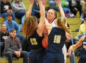  ??  ?? Boyertown’s Kylie Webb dribbles into the double-team defense of Spring-Ford’s Alyssa Conway (13) and Lauren Mensch (10) during the second quarter Tuesday. (Austin Hertzog - Digital First Media)