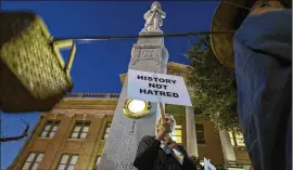  ?? RODOLFO GONZALEZ / AUSTIN AMERICAN-STATESMAN 2015 ?? Laura Fenwick, of Taylor, holds a protest sign in front of the Confederat­e monument outside of the Williamson County Courthouse in January 2015. A group of local residents wants a historical marker that tells “the truth” about the monument’s history to...