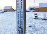  ?? SAKHALIFE.RU VIA ASSOCIATED PRESS ?? In this photo taken on Sunday, a thermomete­r shows the temperatur­e at -65 C in Tomtor village in the east of Yakutia.