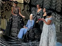  ??  ?? Taraji P. Henson, Octavia Spencer, right, Janelle Monae, left, and Katherine Johnson, in wheelchair, present for Best Documnetar­y feature.