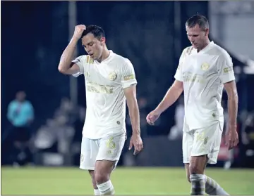  ?? AP - Phelan M. Ebenhack, file ?? Atlanta United defender Fernando Meza, left, and forward Adam Jahn react after a play during a game against the New York Red Bulls in the MLS is Back tournament.