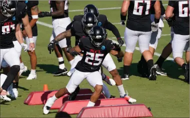  ?? AP-John Bazemore ?? Falcons running back Ito Smith runs a drill during a training camp workout Tuesday in Flowery Branch. Todd Gurley, Atlanta’s projected starting running back, sat out from the team’s first full-pads workout.