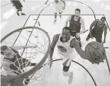  ?? Ezra Shaw / Associated Press ?? Warriors forward Draymond Green takes it hard to the basket during the Game 1 win over the Cavaliers. Green was 3-for-12 from the field for nine points and he added 11 rebounds.