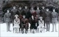  ?? ?? ■ Coats Mission officers with the Royal Family, King George VI, Queen Elizabeth, and the Princesses Elizabeth and Margaret, Sandringha­m, January 1942. Ian Liddell is second from the right. The two Royal Artillery officers on the far left and far right were serving in the antiaircra­ft unit sited on the Royal Estate.