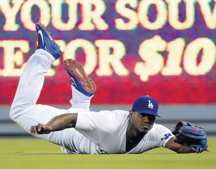  ?? HARRY HOW/GETTY ?? In 2012 Yasiel Puig was a migrant who used trafficker­s to help him defect from Cuba to the US. Now he earns millions playing for the Los Angeles Dodgers in Major League Baseball