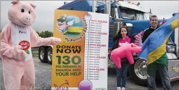  ??  ?? Shane McAuliffe holding the new Rwandan flag with his sister, Natasha and Percy - The Truly Irish Pig at the launch of the Fly Ronnie to Rwanda Campaign in Castleisla­nd on Sunday. Photo: John Reidy