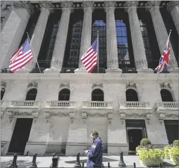  ?? AP PHOTO/MARY ALTAFFER ?? A trader looks over his cell phone outside the New York Stock Exchange on Sept. 14, 2022, in the financial district of Manhattan in New York.