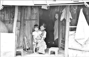  ??  ?? Pyndaplin Shabong, 39, with her daughter at her house in Kongthong village.