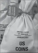  ??  ?? UNSEARCHED: Pictured above are the unsearched Vault Bags loaded with nearly 3 pounds of U.S. Gov’t issued coins some dating back to the 1800’s being handed over to Michigan residents by Federated Mint.