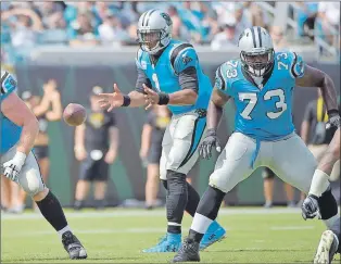  ?? AP PHOTO ?? After Michael Oher (right) was cut by the Tennessee Titans one year into a $20-million, four-year contract, Cam Newton reached out to him so he signed with the Carolina Panthers and went on to have a solid season protecting the quarterbac­k’s blind side.