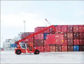  ?? SAHIBA CHAWDHARY ?? A cargo container is lifted for shipping earlier this year at the Sihanoukvi­lle Autonomous Port.