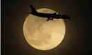  ??  ?? A plane is silhouette­d by the rising supermoon as it approaches Louisville internatio­nal airport in Kentucky on Monday, 26 April 2021. Photograph: Charlie Riedel/AP