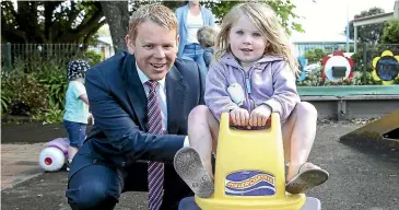  ?? KEVIN STENT/STUFF ?? Education Minister Chris Hipkins gives Lucy Turner, 3, a helping hand at Knox Church Playgroup in Lower Hutt where he launched the Government’s draft strategic plan for early learning.