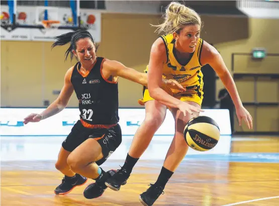  ?? REMATCH: The Fire's Micaela Cocks has the ball stolen by former Flames player Lauren Nicholson in the WNBL semi- final in March. Picture: ZAK SIMMONDS ??