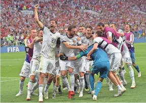  ?? PETER POWELL/EPA-EFE ?? Members of Russia’s team celebrate after beating Spain on Sunday to advance to the World Cup quarterfin­als.