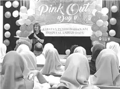  ??  ?? Christy sharing her breast cancer journey with women during the breast cancer awareness campaign in Lahad Datu.