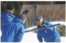  ?? Rich Pedroncell­i / Associated Press ?? Jeremy Hill (left), Andy Reising and Sean de Guzman of the state Department of Water Resources check snow levels.