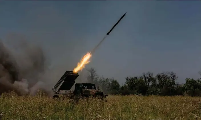  ?? Photograph: Anadolu Agency/Getty Images ?? A Ukrainian artillery vehicle fires a rocket on Russian positions in Bakhmut where Putin’s forces are allegedly being encircled.