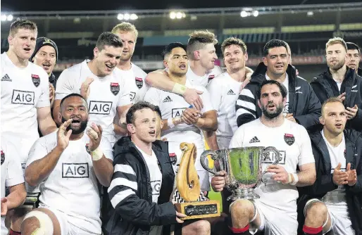  ?? PHOTO: GETTY IMAGES ?? Pride of the South . . . South halfback Brad Weber (left) and captain Sam Whitelock hold the trophies after South’s 3835 win over North in the interislan­d clash in Wellington on Saturday.