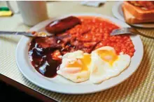  ?? AFP ?? A third of UK chicken farmers have already scaled back production of eggs, which round off the typical English breakfast along with bacon, sausages and baked beans.