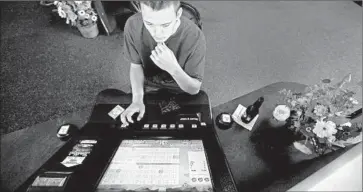  ?? Photograph­s by Francine Orr
Los Angeles Times ?? JORDAN BEHR , 21, of Las Vegas gambles at Dotty’s Gaming &amp; Spirits in Henderson, Nev. He said he likes to frequent the casino-bar chain because of the “cheap cigarettes” and he knows the regular bartender.