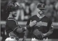  ?? The Associated Press ?? ALL SMILES: Cleveland Indians starting pitcher Corey Kluber, right, and catcher Yan Gomes celebrate the team’s 2-0 victory over the Detroit Tigers on Sept. 12 in Cleveland. Kluber won his second American League Cy Young Award Wednesday, receiving 28 of...