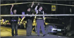  ?? AP/Chicago Tribune/JOHN J. KIM ?? Police lift crime scene tape after two people were shot and transporte­d to Stroger Hospital in Chicago in September. Chicago homicides fell from 771 in 2016 to 650 last year, but raging gang wars in the city’s most violent neighborho­ods drove the total...