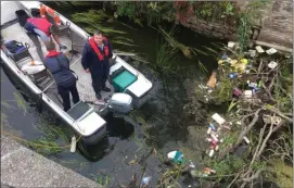  ??  ?? Volunteers from ‘Fermoy A Cleaner Town’ clearing litter from the sluice gates and south bank of the River Blackwater in the town last Saturday.