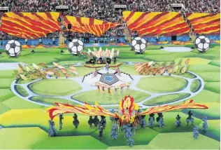  ?? PHOTOS: GETTY IMAGES ?? Let’s get this party started . . . (clockwise from left) A performer juggles footballs during the opening ceremony of the 2018 World Cup at Luzhniki Stadium in Moscow yesterday; the ceremony featured the usual mix of colour and choreograp­hy; Robbie...