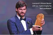  ??  ?? Liverpool's Alisson Becker with Lev Yashin trophy for best goalkeeper