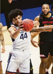  ?? Robert Franklin / Associated Press ?? UConn’s Andre Jackson (44) grabs a rebound during a 2021 first-round NCAA Tournament game against Maryland.