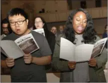  ?? REBECCA BREYER — ASSOCIATED PRESS ?? Enoch Bang, left, and Tayler Bolton sing during the Ecumenical Election Day Communion Service on Tuesday at the Decatur First United Methodist Church in Decatur, Ga.