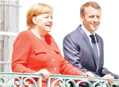  ?? — AFP photo ?? Merkel welcomes French President Emmanuel Macron as he arrives at Meseberg Palace, northeaste­rn Germany before holding a ministeria­l conference to coordinate European reform proposals ahead of the EU summit to take place from June 28 to 29.