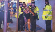  ?? REX FEATURES VIA AP ?? Police help the injured late Monday after multiple reports of an explosion at Manchester Arena in northern England.