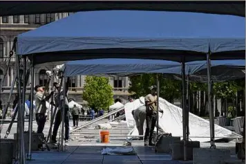  ?? Will Waldron/times Union ?? Canopies are erected on Empire State Plaza ahead of Thursday’s CDPHP Workforce Team Challenge on Wednesday. The race was held in Altamont last year due to COVID precaution­s.