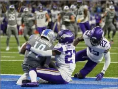  ?? The Associated Press ?? Lions wide receiver Amon-Ra St. Brown catches an 11-yard pass for a touchdown on the last play of the game.