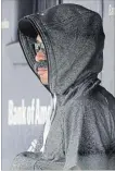  ?? ASSOCIATED PRESS FILE PHOTO ?? Ichiro Suzuki wears a fake moustache and a hoodie as he sits in the Seattle dugout during the first inning of a game on June 21 at Yankee Stadium.